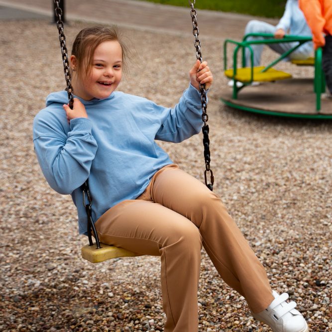 side-view-girl-with-down-syndrome-swing